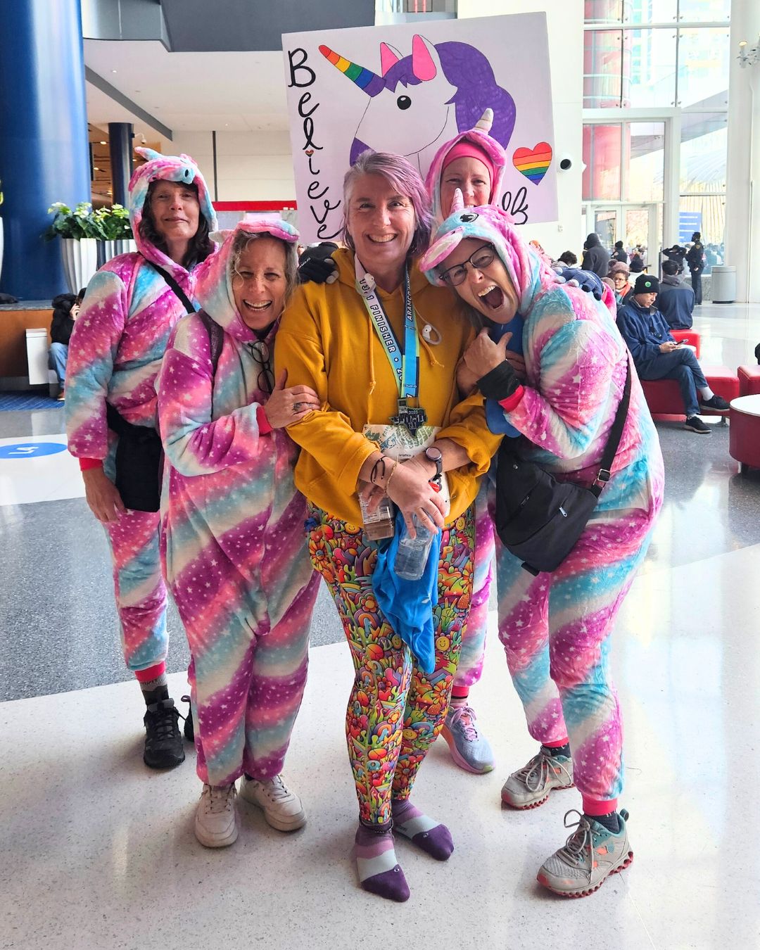 getyourgoal-membership-supportive-community-belonging Happy Get Your GOAL community members in sparkling unicorn outfits supporting a member at her half marathon.