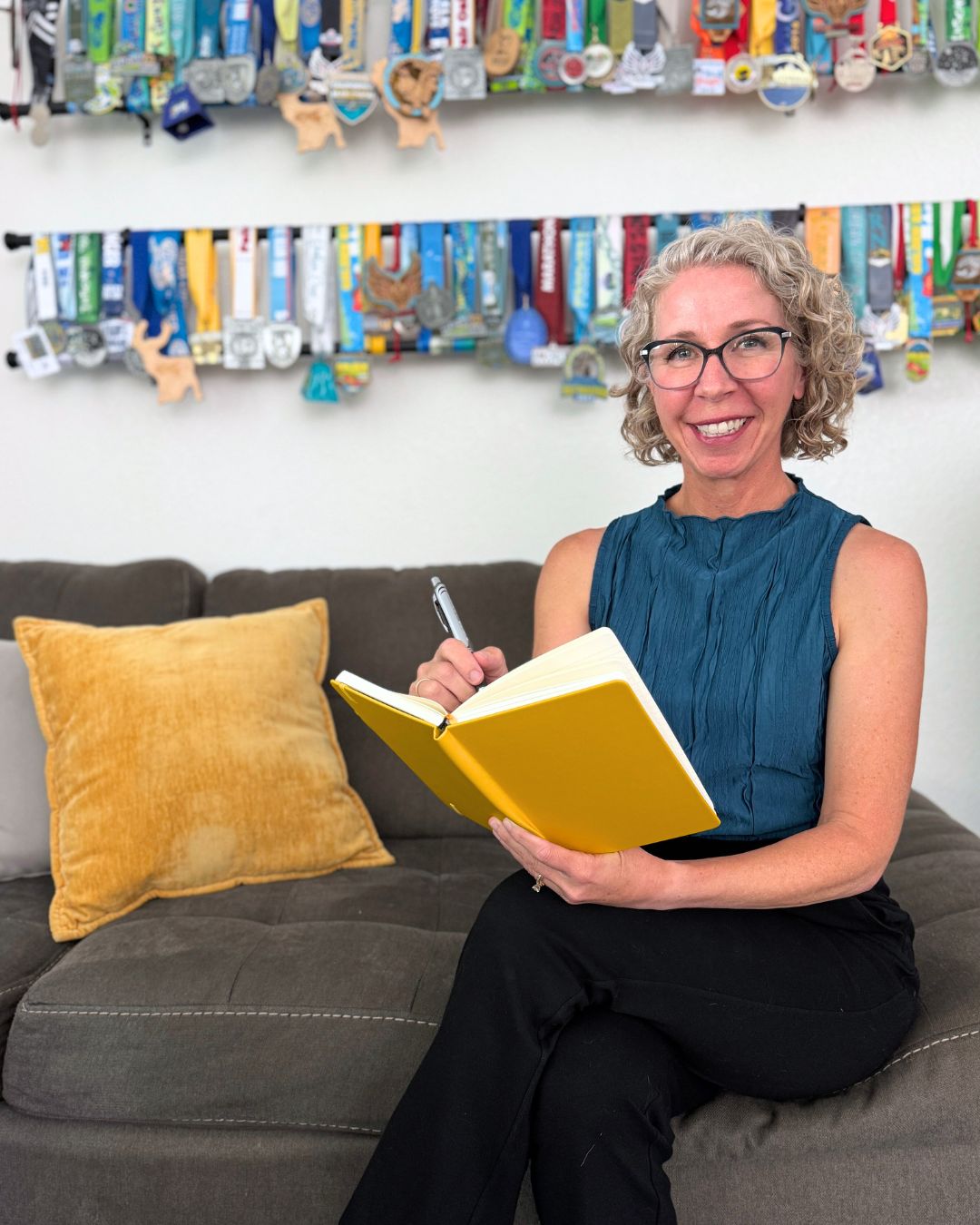 Daily 3 creator Pahla B, journaling on her couch